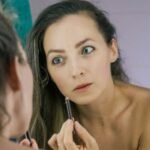 a woman is looking at her reflection in the mirror